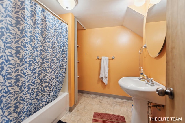 4542 Pinehurst Ave SW, Grand Rapids, MI 49548 - full bath with shower / bath combo with shower curtain, baseboards, and lofted ceiling