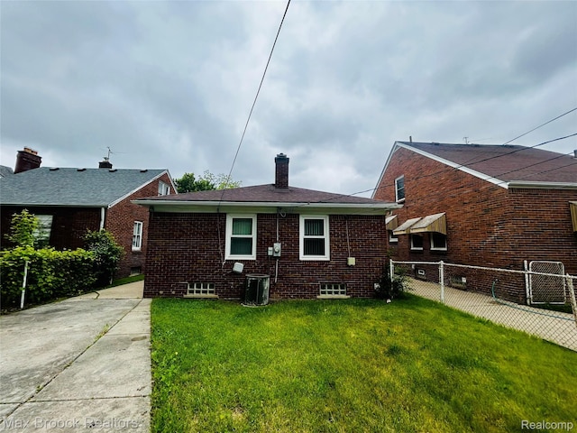 20236 Spencer St, Detroit, MI 48234 - back of house with a chimney, brick siding, and central air condition unit