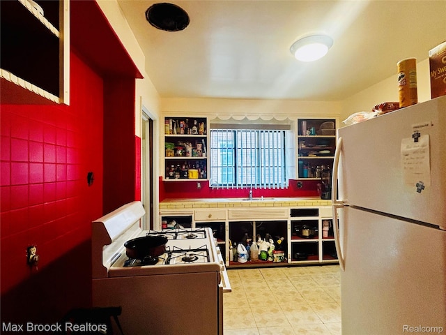 20236 Spencer St, Detroit, MI 48234 - kitchen with white appliances, open shelves, a sink, and built in shelves