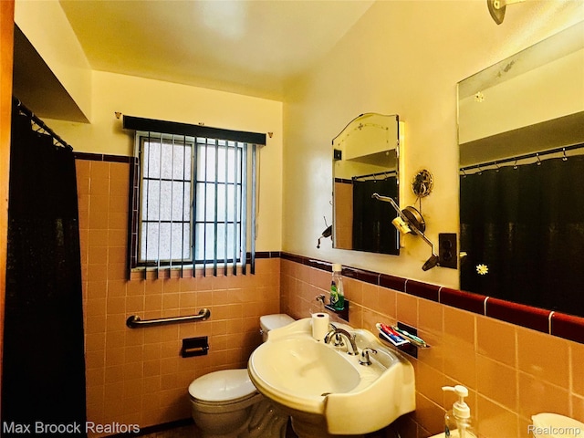 20236 Spencer St, Detroit, MI 48234 - bathroom featuring toilet, tile walls, wainscoting, a sink, and curtained shower