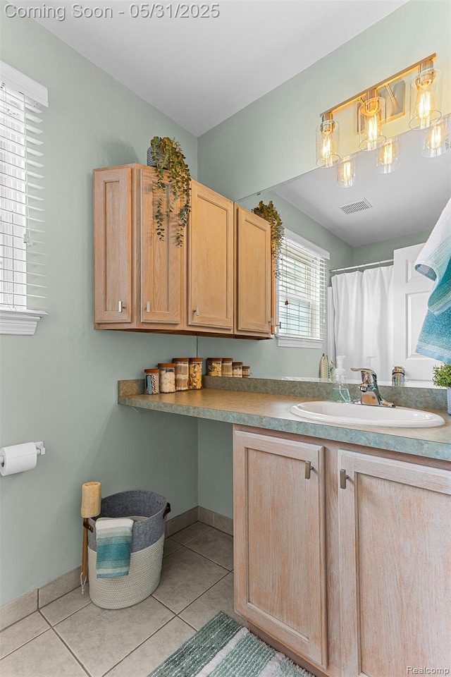 21106 Collingham Ave, Farmington Hills, MI 48336 - kitchen featuring a sink, light brown cabinetry, light tile patterned flooring, and baseboards