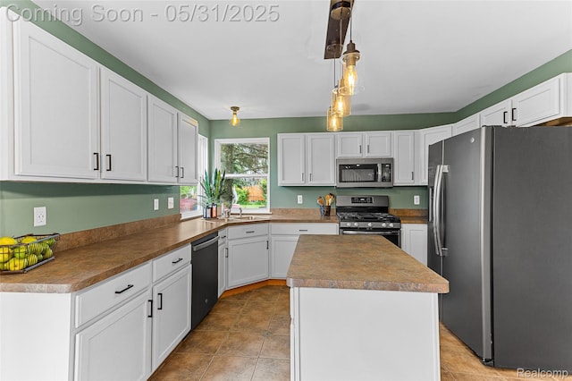 21106 Collingham Ave, Farmington Hills, MI 48336 - kitchen featuring appliances with stainless steel finishes, a kitchen island, white cabinetry, and light tile patterned floors