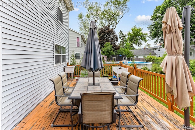 21106 Collingham Ave, Farmington Hills, MI 48336 - wooden deck with an outdoor pool and outdoor dining area
