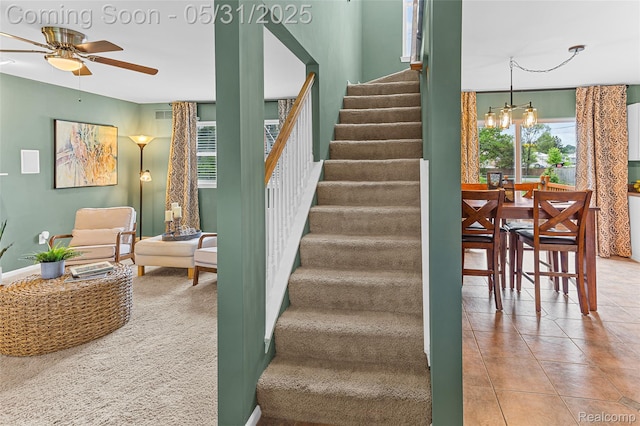 21106 Collingham Ave, Farmington Hills, MI 48336 - staircase with ceiling fan, plenty of natural light, tile patterned floors, and a chandelier