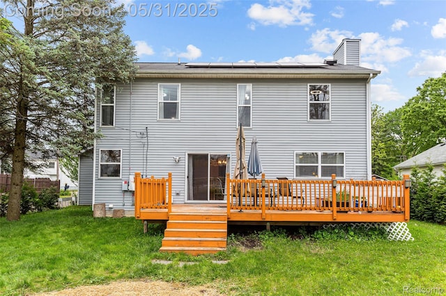 21106 Collingham Ave, Farmington Hills, MI 48336 - back of house featuring a yard, roof mounted solar panels, a chimney, and a wooden deck