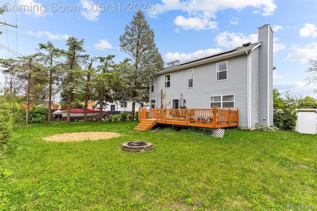 21106 Collingham Ave, Farmington Hills, MI 48336 - rear view of house featuring an outdoor fire pit, a chimney, a wooden deck, and a yard