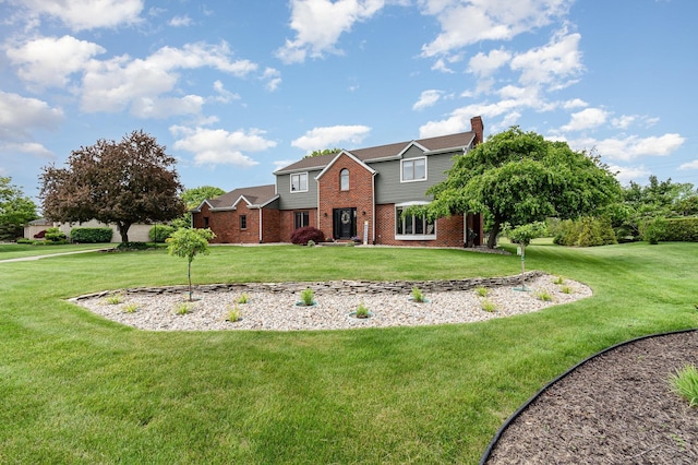 3677 W White Trillium Dr, Saginaw, MI 48603 - view of front facade with brick siding, a chimney, and a front lawn