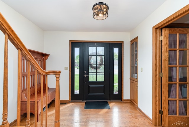 3677 W White Trillium Dr, Saginaw, MI 48603 - foyer featuring light wood-type flooring, stairs, and baseboards