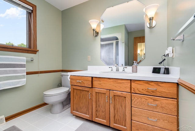 3677 W White Trillium Dr, Saginaw, MI 48603 - bathroom with vanity, toilet, baseboards, a shower stall, and tile patterned floors