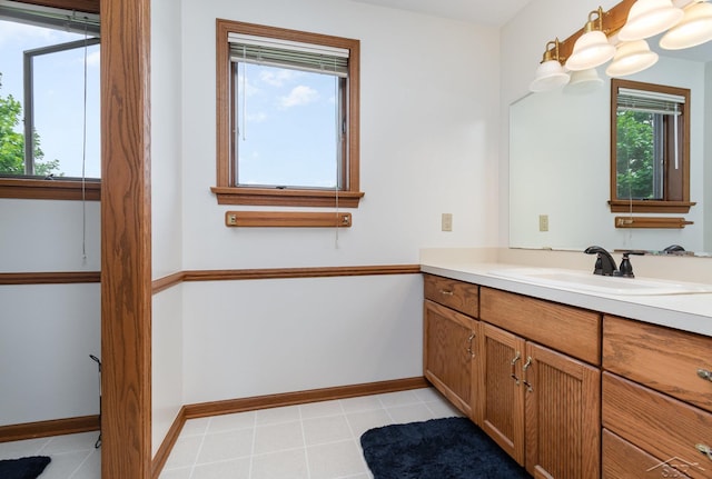 3677 W White Trillium Dr, Saginaw, MI 48603 - bathroom featuring vanity, baseboards, and tile patterned flooring