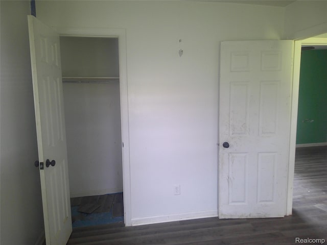 7499 Burt Rd, Birch Run, MI 48415 - unfurnished bedroom featuring a closet, wood finished floors, and baseboards