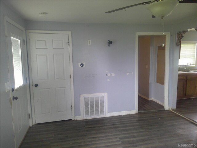 7499 Burt Rd, Birch Run, MI 48415 - empty room featuring a sink, wood finished floors, and baseboards