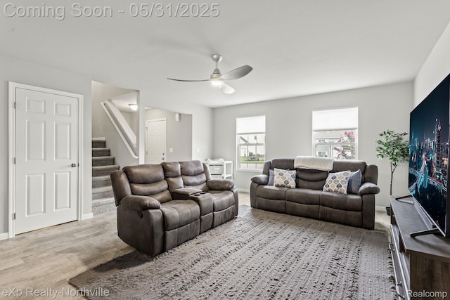 342 Lotz Ct, Wayland, MI 49348 - living area featuring ceiling fan, stairs, wood finished floors, and baseboards
