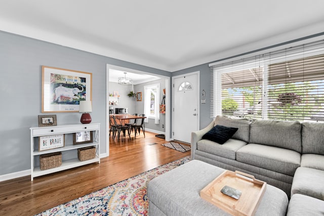 3822 Polk St, Dearborn, MI 48124 - living room with wood finished floors, a chandelier, and baseboards