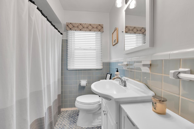 3822 Polk St, Dearborn, MI 48124 - bathroom featuring vanity, tile walls, toilet, tile patterned floors, and plenty of natural light