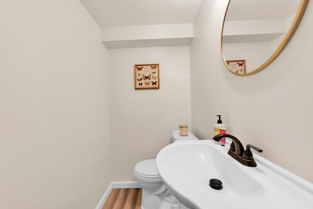 3822 Polk St, Dearborn, MI 48124 - bathroom with wood finished floors, a sink, toilet, and baseboards