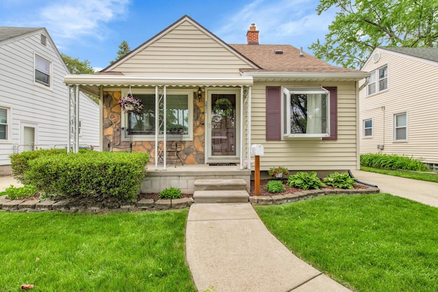 3822 Polk St, Dearborn, MI 48124 - bungalow featuring a porch, a front yard, a chimney, and a shingled roof