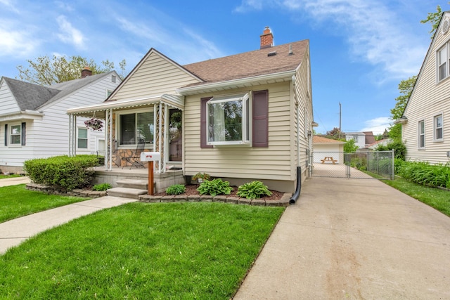 3822 Polk St, Dearborn, MI 48124 - bungalow-style house featuring covered porch, a gate, a chimney, roof with shingles, and a detached garage