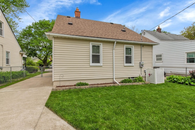 3822 Polk St, Dearborn, MI 48124 - rear view of property featuring a shingled roof and a chimney