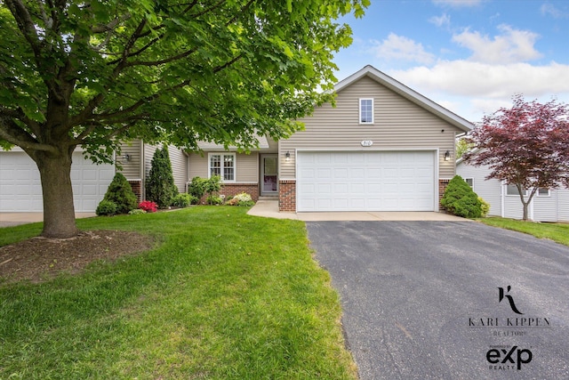 310 Timber Creek Cir NW, Comstock Park, MI 49321 - view of property hidden behind natural elements featuring brick siding, asphalt driveway, a front lawn, and a garage