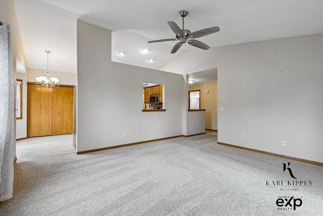 310 Timber Creek Cir NW, Comstock Park, MI 49321 - spare room featuring light colored carpet, lofted ceiling, a ceiling fan, a chandelier, and baseboards
