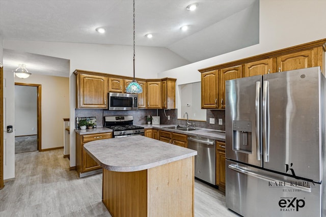 310 Timber Creek Cir NW, Comstock Park, MI 49321 - kitchen featuring appliances with stainless steel finishes, a sink, lofted ceiling, a center island, and light wood-style floors