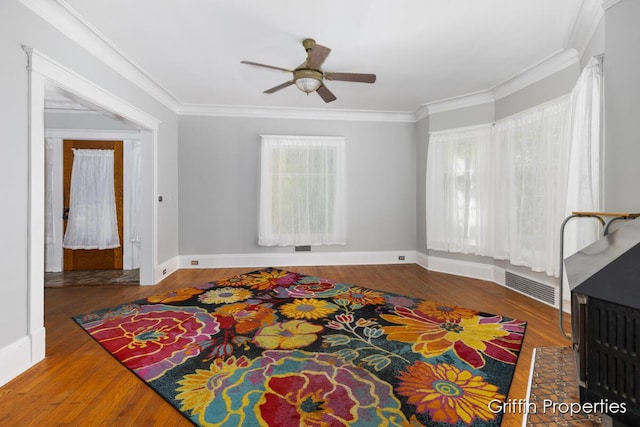 331 Carlton Ave SE, Grand Rapids, MI 49506 - living room featuring crown molding, ceiling fan, wood finished floors, and baseboards
