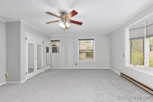331 Carlton Ave SE, Grand Rapids, MI 49506 - carpeted empty room with a baseboard radiator, ornamental molding, a ceiling fan, and baseboards