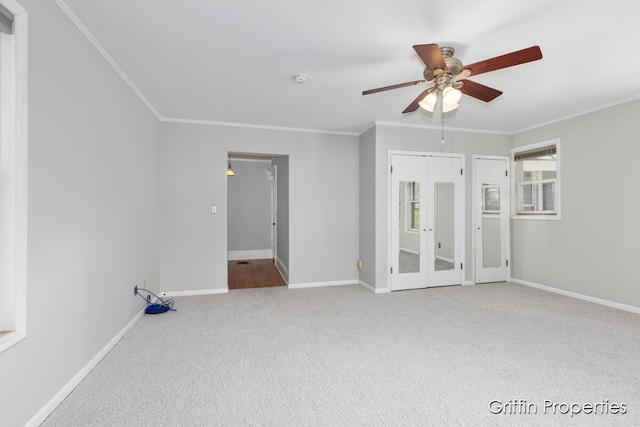 331 Carlton Ave SE, Grand Rapids, MI 49506 - empty room featuring carpet, ceiling fan, ornamental molding, baseboards, and french doors