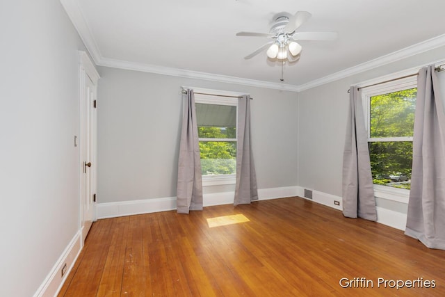 331 Carlton Ave SE, Grand Rapids, MI 49506 - unfurnished room with healthy amount of natural light, wood finished floors, ornamental molding, a ceiling fan, and baseboards