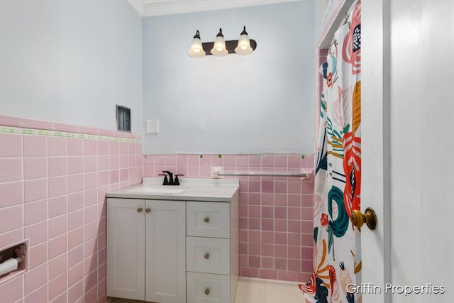 331 Carlton Ave SE, Grand Rapids, MI 49506 - bathroom featuring tile walls, vanity, wainscoting, ornamental molding, and a shower with shower curtain