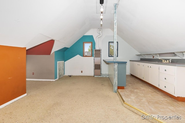331 Carlton Ave SE, Grand Rapids, MI 49506 - additional living space with lofted ceiling, baseboards, light colored carpet, and a sink