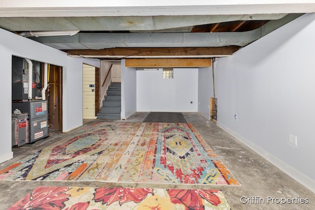 331 Carlton Ave SE, Grand Rapids, MI 49506 - finished below grade area featuring stairs, baseboards, and heating unit