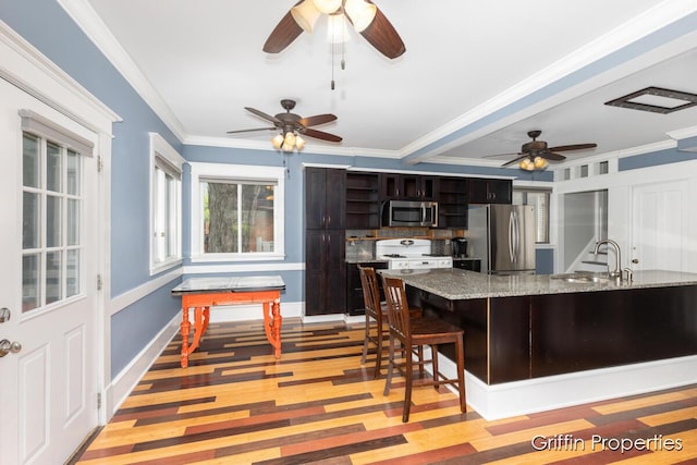 331 Carlton Ave SE, Grand Rapids, MI 49506 - kitchen with appliances with stainless steel finishes, a sink, a ceiling fan, open shelves, and light wood-style floors