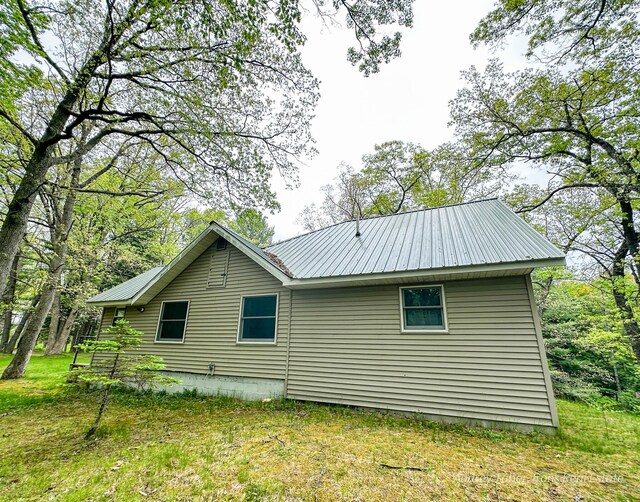 4307 N Mac Rd, Irons, MI 49644 - view of property exterior with a metal roof