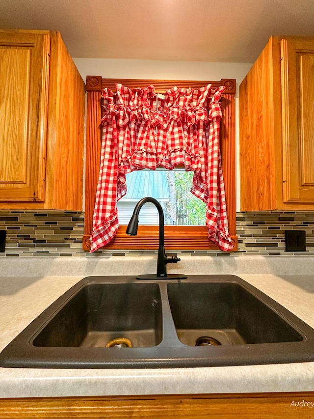 4307 N Mac Rd, Irons, MI 49644 - kitchen view of tasteful backsplash, brown cabinets, and light countertops