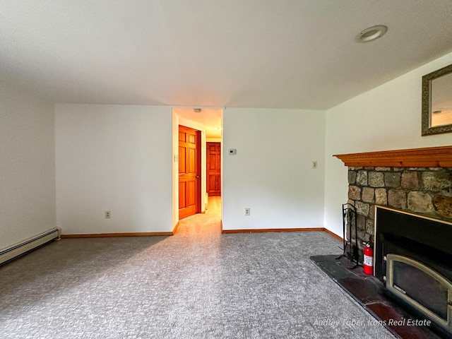 4307 N Mac Rd, Irons, MI 49644 - unfurnished living room featuring carpet floors, baseboard heating, and a wood stove