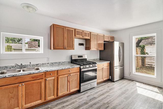 204 E Clinton St, Durand, MI 48429 - kitchen with stainless steel appliances, plenty of natural light, and light wood-style floors