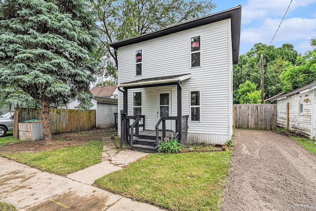 204 E Clinton St, Durand, MI 48429 - view of front facade featuring a fenced backyard and asphalt driveway