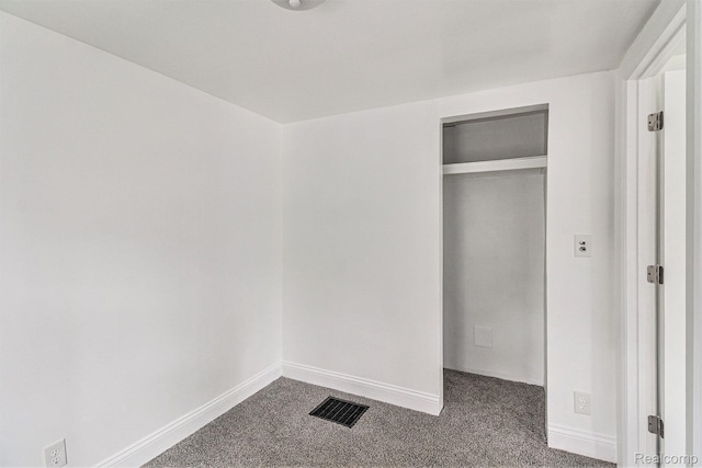204 E Clinton St, Durand, MI 48429 - unfurnished bedroom with dark carpet and a closet