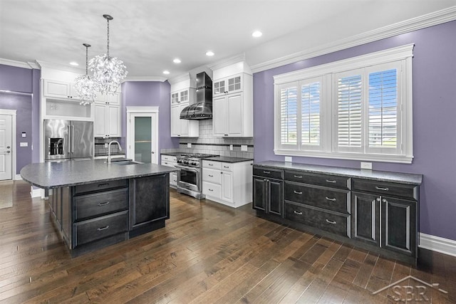 10399 Webster Rd, Freeland, MI 48623 - kitchen featuring appliances with stainless steel finishes, wall chimney exhaust hood, white cabinets, a sink, and recessed lighting