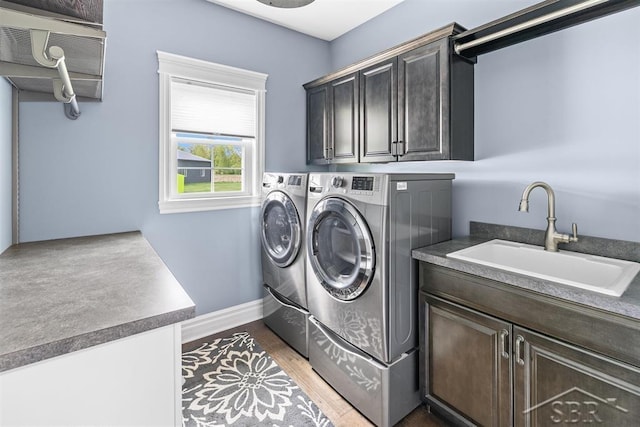 10399 Webster Rd, Freeland, MI 48623 - laundry area with cabinet space, washing machine and dryer, and baseboards