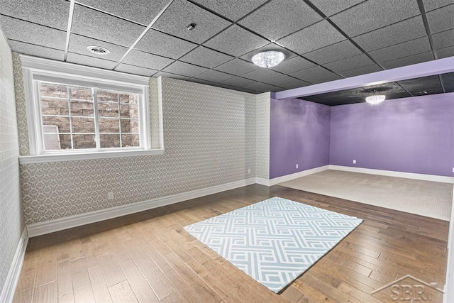 10399 Webster Rd, Freeland, MI 48623 - below grade area featuring hardwood / wood-style flooring, baseboards, wallpapered walls, and a drop ceiling
