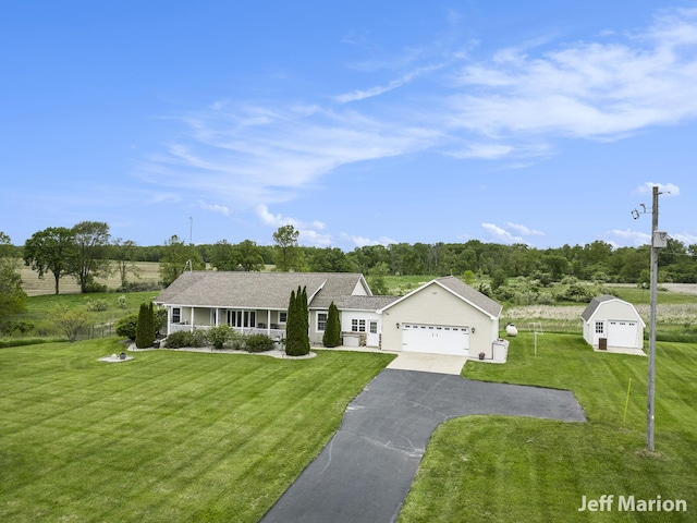 2057 Nickleplate Rd, Ionia, MI 48846 - single story home with driveway, a garage, and covered porch