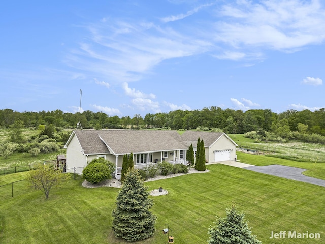 2057 Nickleplate Rd, Ionia, MI 48846 - ranch-style house with concrete driveway, a garage, and a porch