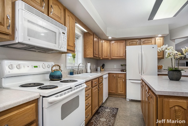 2057 Nickleplate Rd, Ionia, MI 48846 - kitchen with white appliances, a sink, brown cabinets, and light countertops