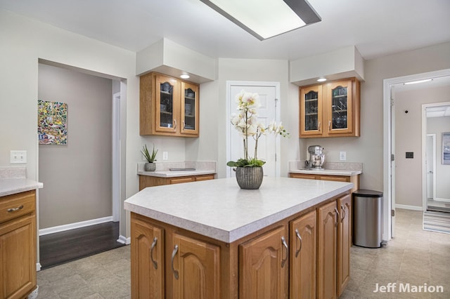 2057 Nickleplate Rd, Ionia, MI 48846 - kitchen with light countertops, brown cabinets, a kitchen island, and baseboards