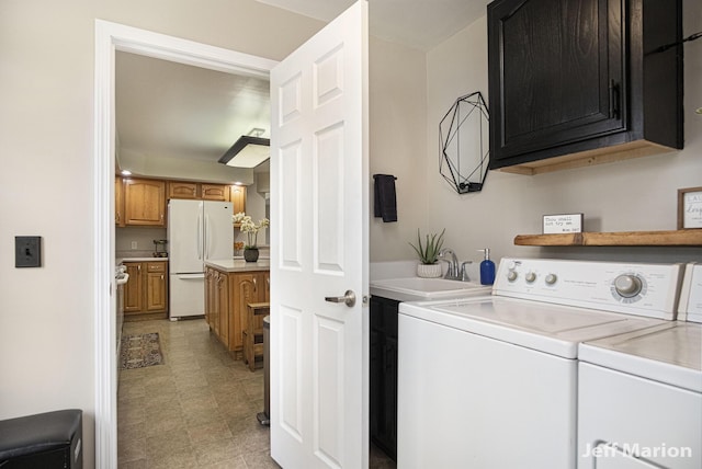 2057 Nickleplate Rd, Ionia, MI 48846 - laundry area featuring cabinet space, washing machine and clothes dryer, and light floors