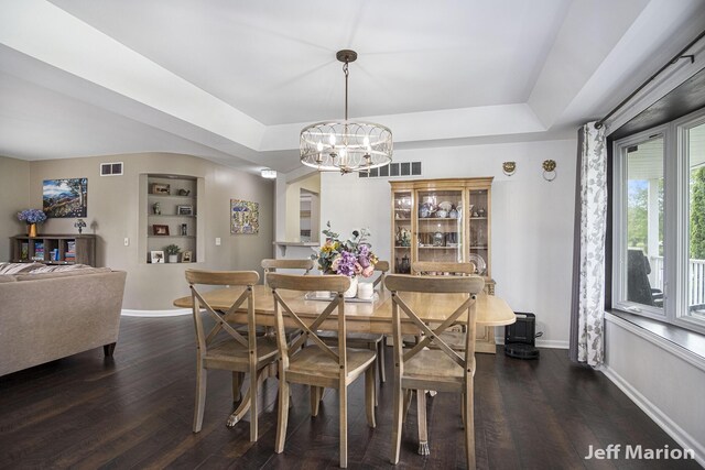 2057 Nickleplate Rd, Ionia, MI 48846 - dining space featuring dark wood-style floors, a chandelier, baseboards, and a raised ceiling