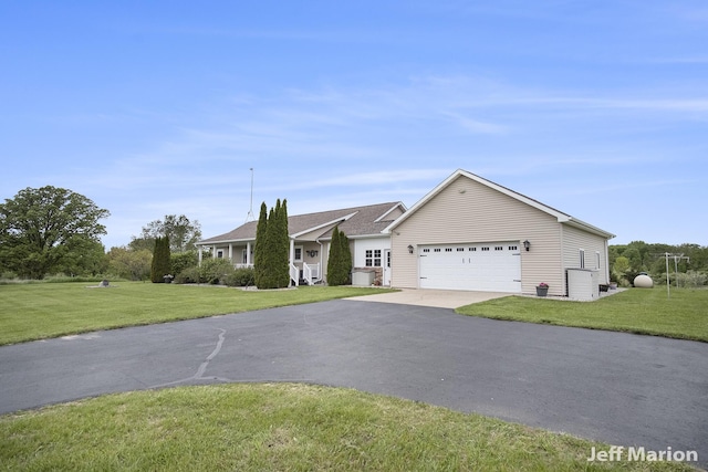 2057 Nickleplate Rd, Ionia, MI 48846 - ranch-style home featuring an attached garage, driveway, and a front lawn